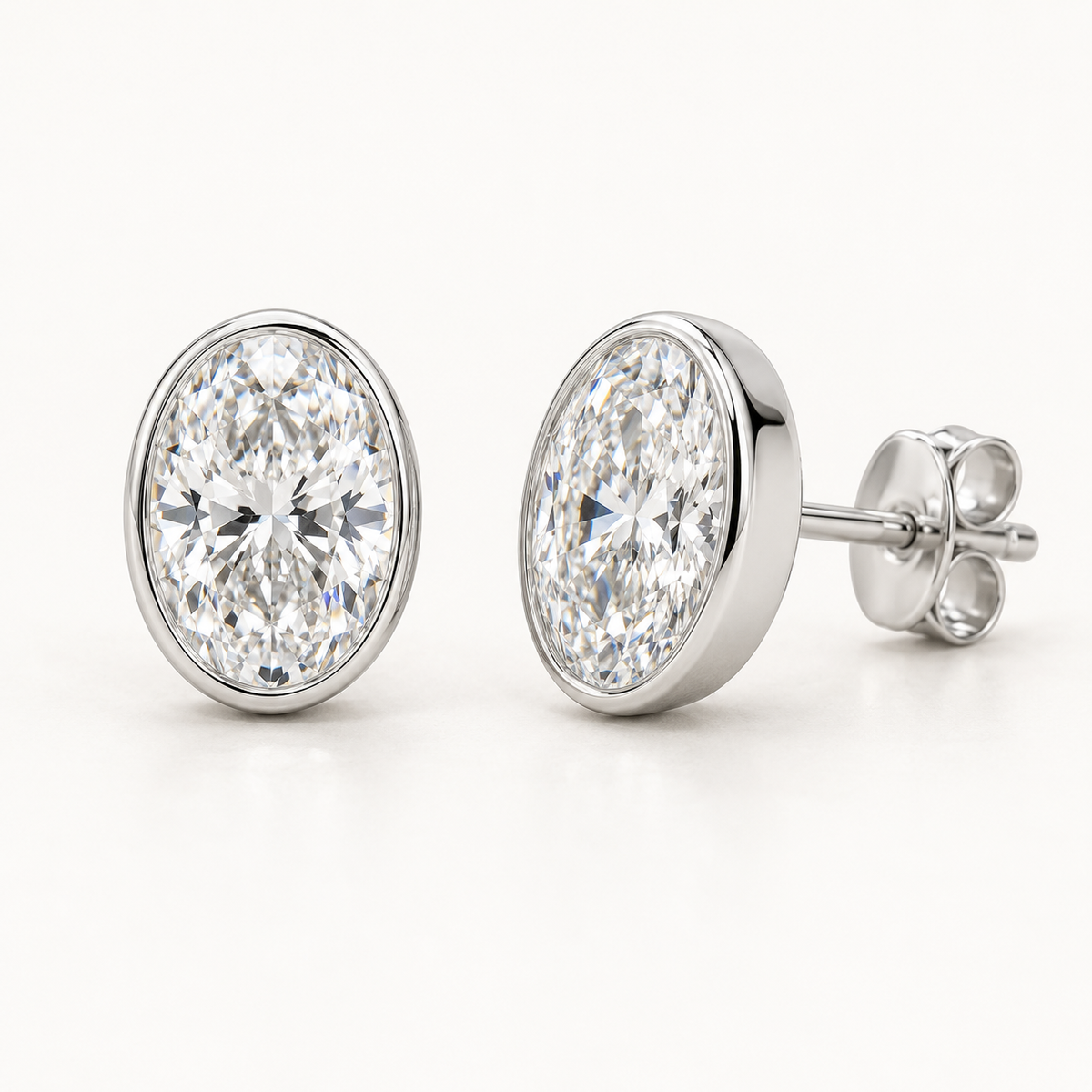 Lunelle Diamond Studs, 2 Carats Total, 14K White Gold, oval diamonds in bezel settings — AI design rendering.